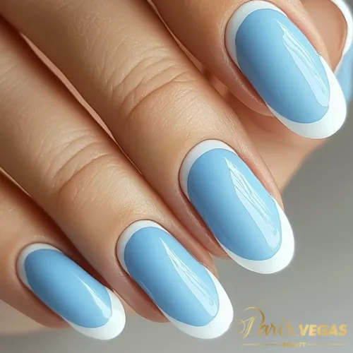 Unhas decorada azul claro com francesinha, design elegante e sofisticado, perfeito para quem deseja uma manicure clássica e moderna ao mesmo tempo, feita em salão de cabeleireiro em Moema.