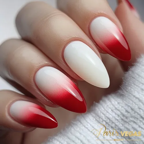 Unhas com degradê vermelho feitas em Moema, São Paulo, para um estilo elegante e vibrante.