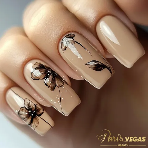 Unhas marrons com desenhos delicados, oferecendo um design sofisticado e refinado.