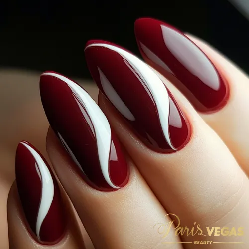 Unhas vinho com curvas em branco, design sofisticado e elegante feito no salão de beleza Paris Vegas Beauty em Moema.